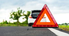 white-car-and-reflector-triangle-on-road_Getty.jpg