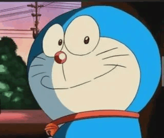 a close up of a cartoon character , doraemon , smiling and looking at something .